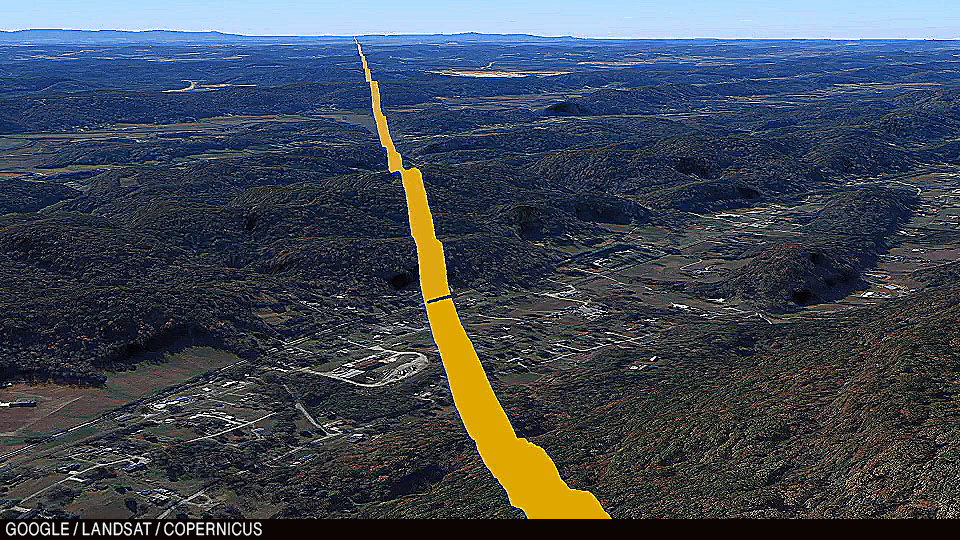 Animation: Zoom in on the stretch of track that passes through the Georgia Tech field. A train is sitting along the field with three cars attached.