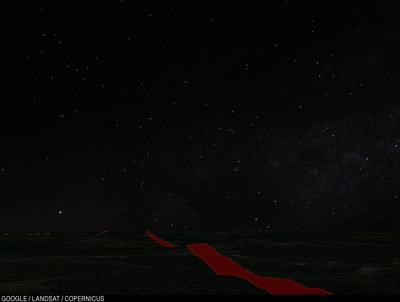 An unspecified field in the dead of night, with stars overhead.